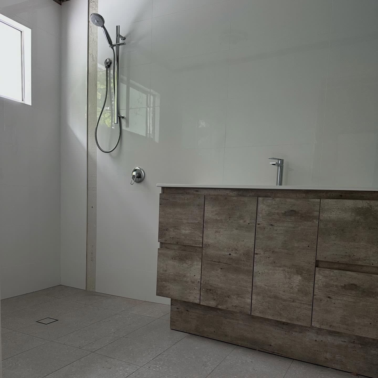 Renovated bathroom with a timber-look vanity and a new shower