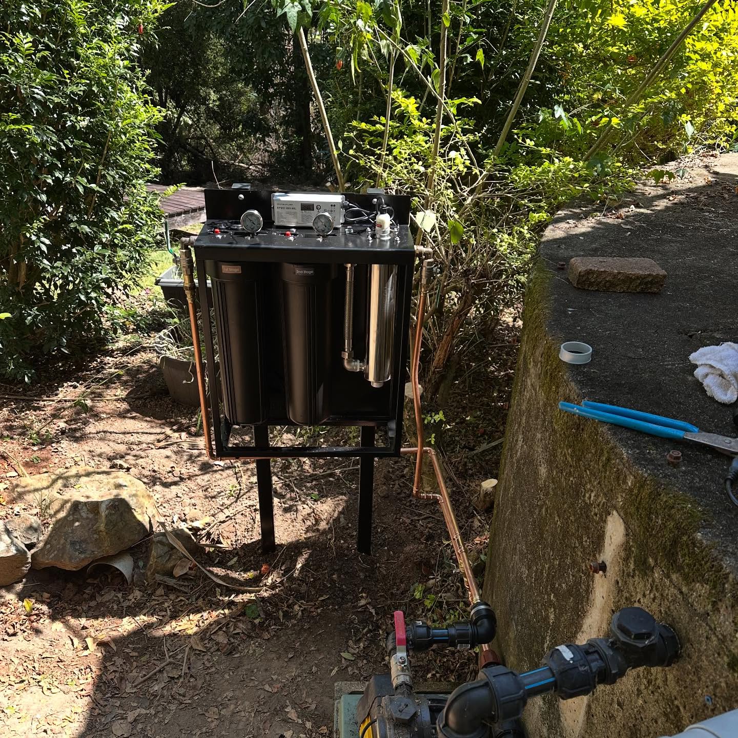 Open water filtration rig with three filter housings on a sloping block